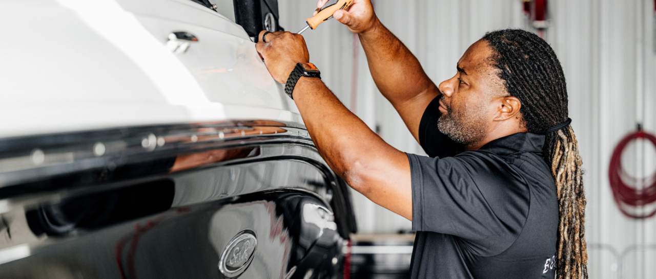 Man refurbishing a used Sea Ray boat