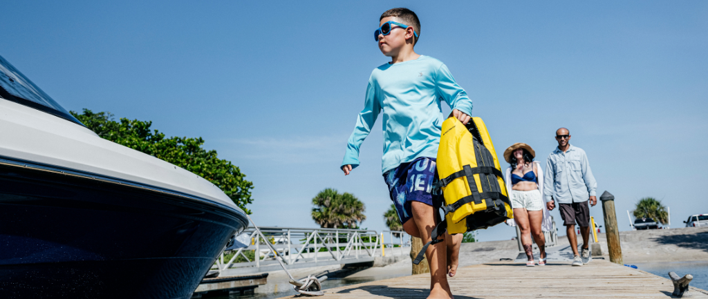Kid walking up to a preowned boat